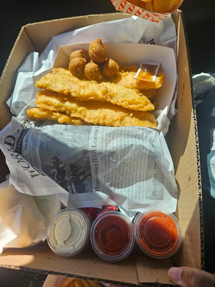 Fish and hush puppies packed in a takeout box